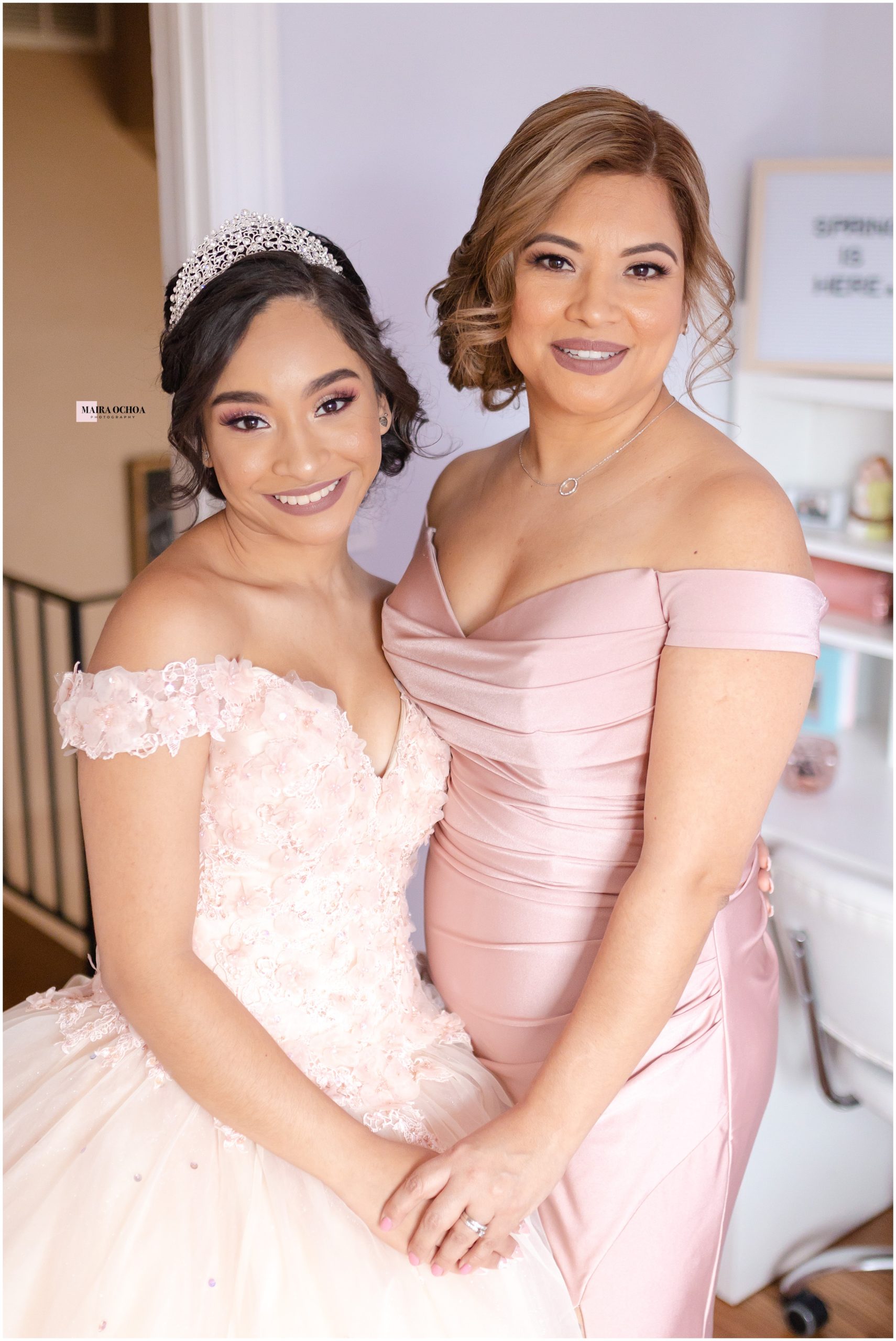 Quinceanera and mom at home in room