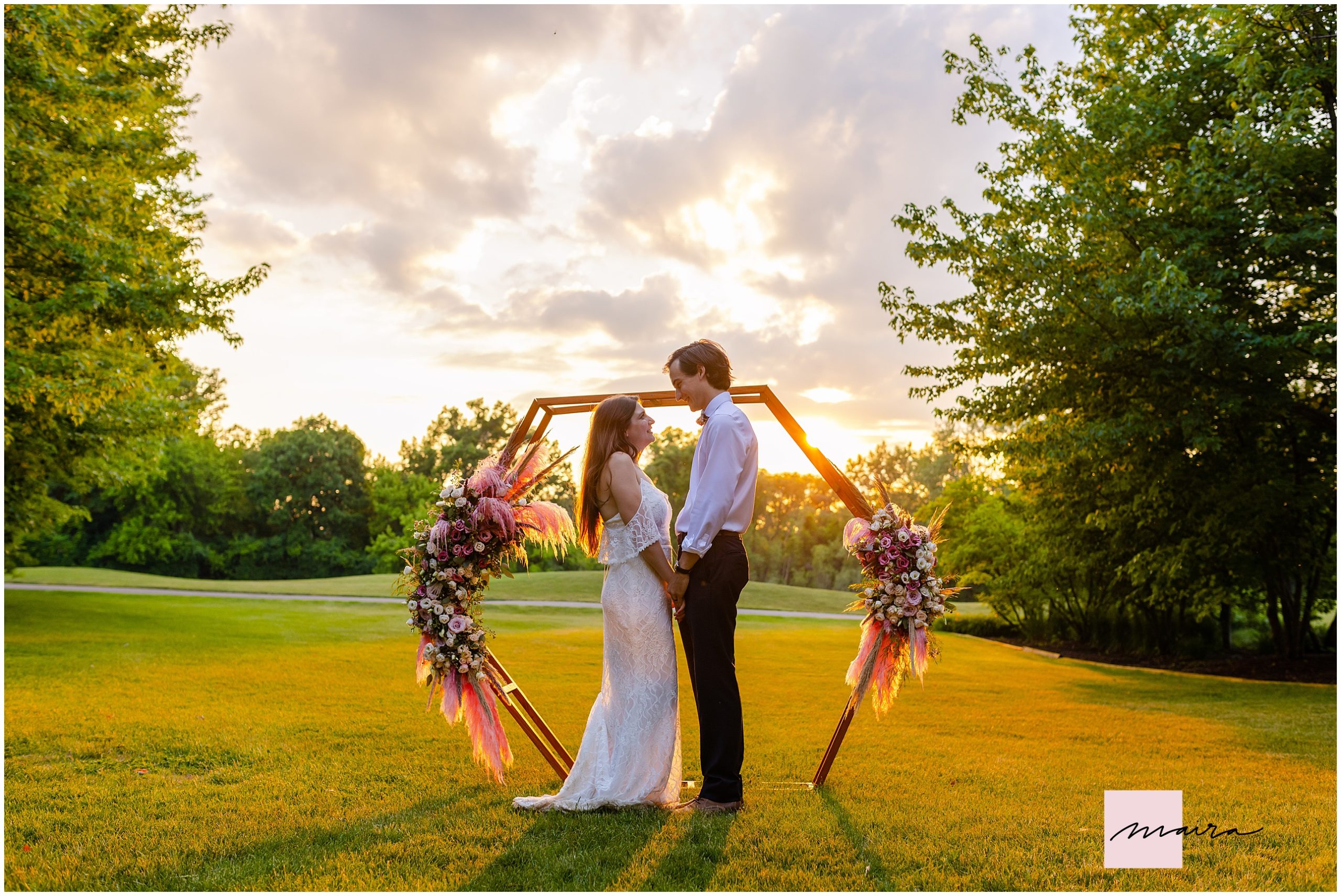 Sunset bride and groom hexagunal wooden arch backdrop wedding