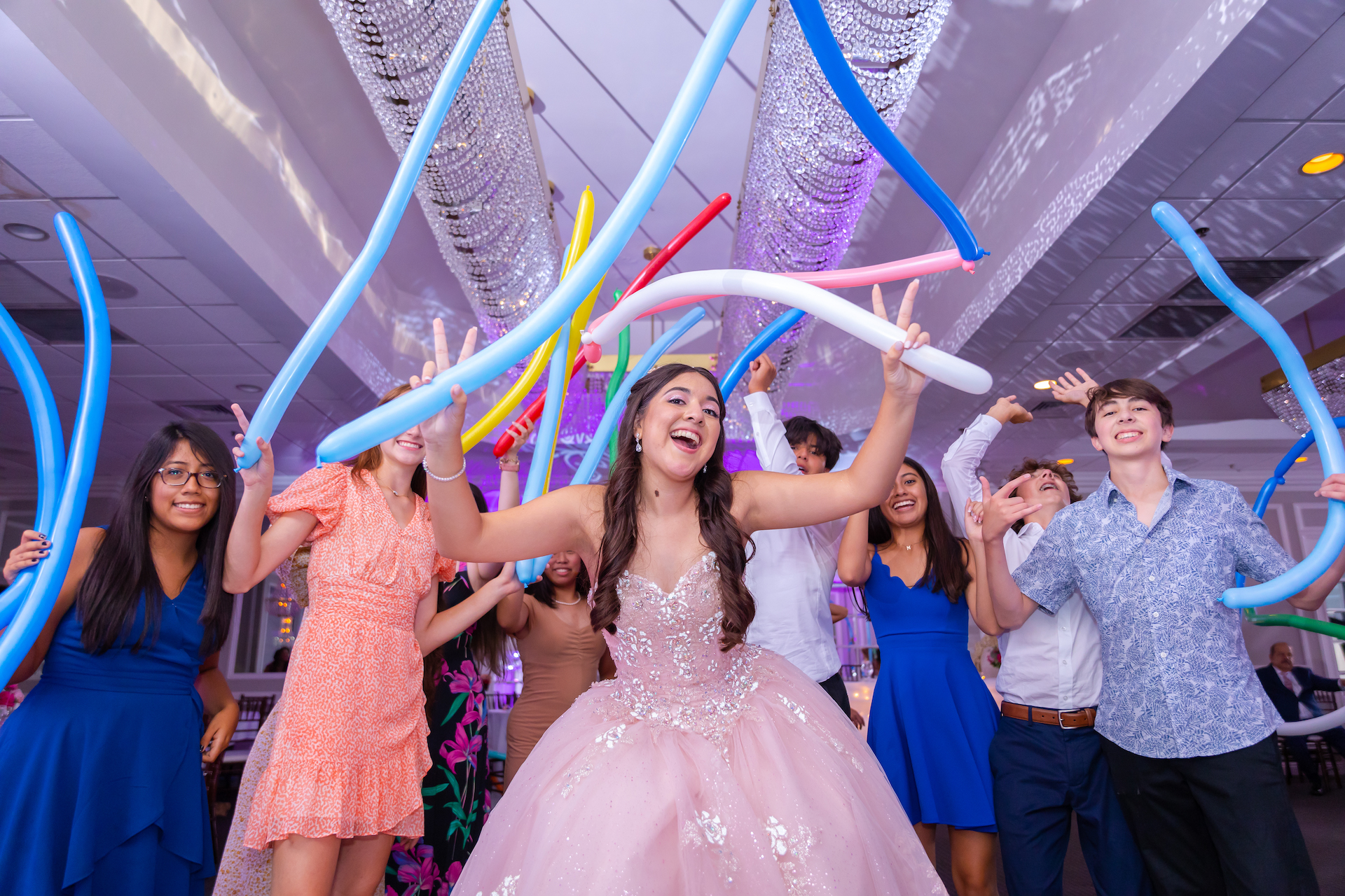 Quinceanera at her party celebrating with friends